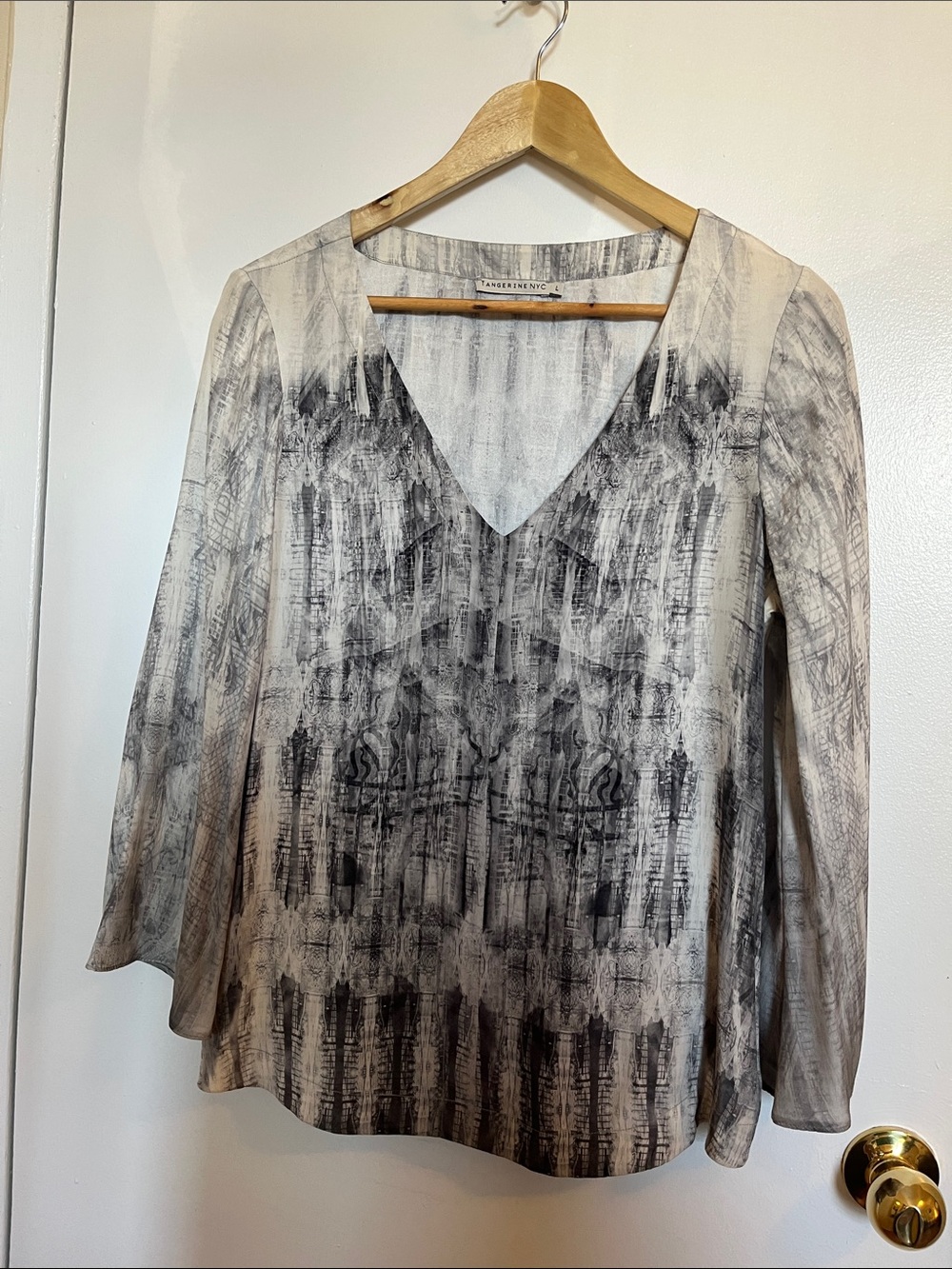 Blouse by Tangerine NYC. Made of 100% silk. Size large.